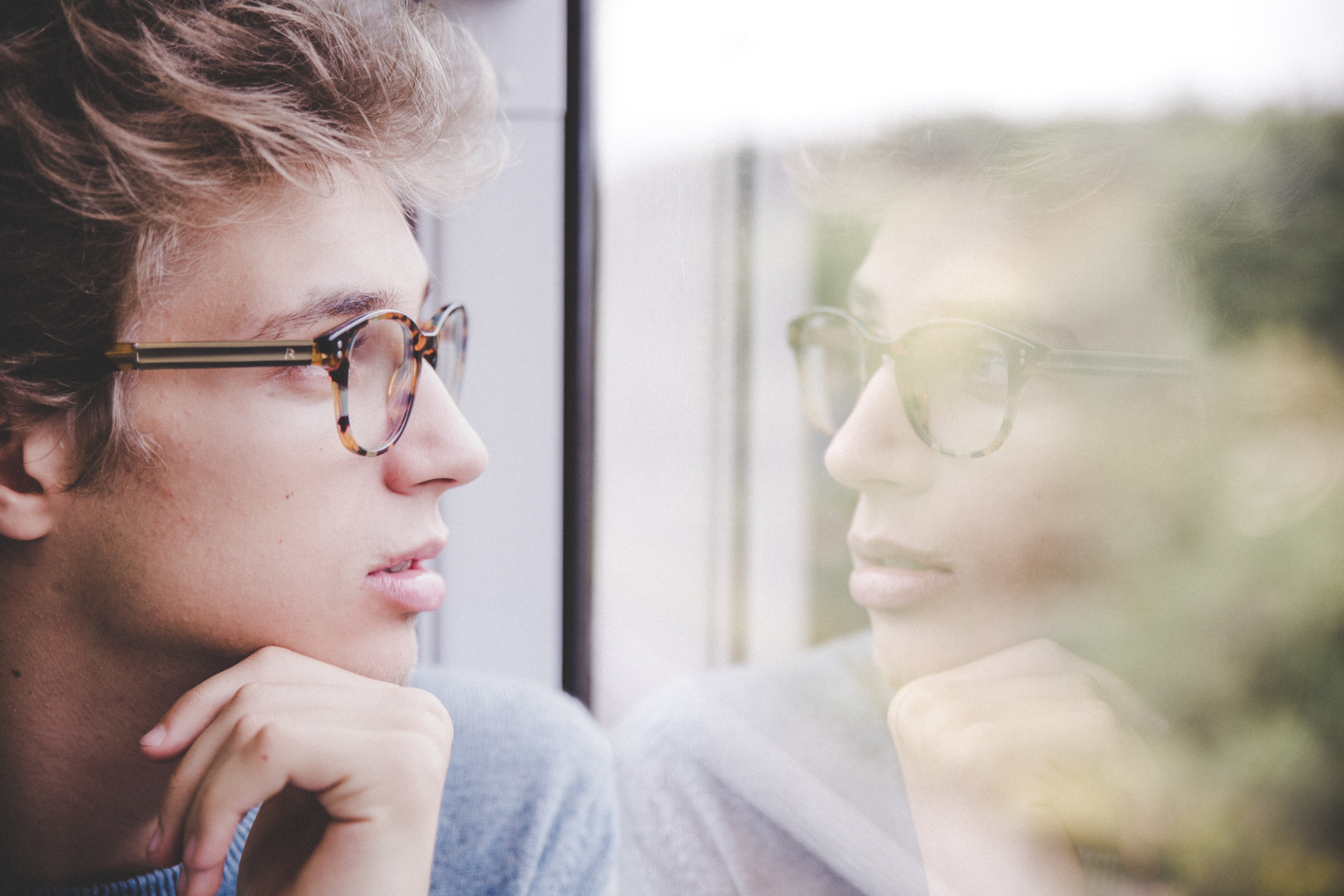 Man looking at reflection